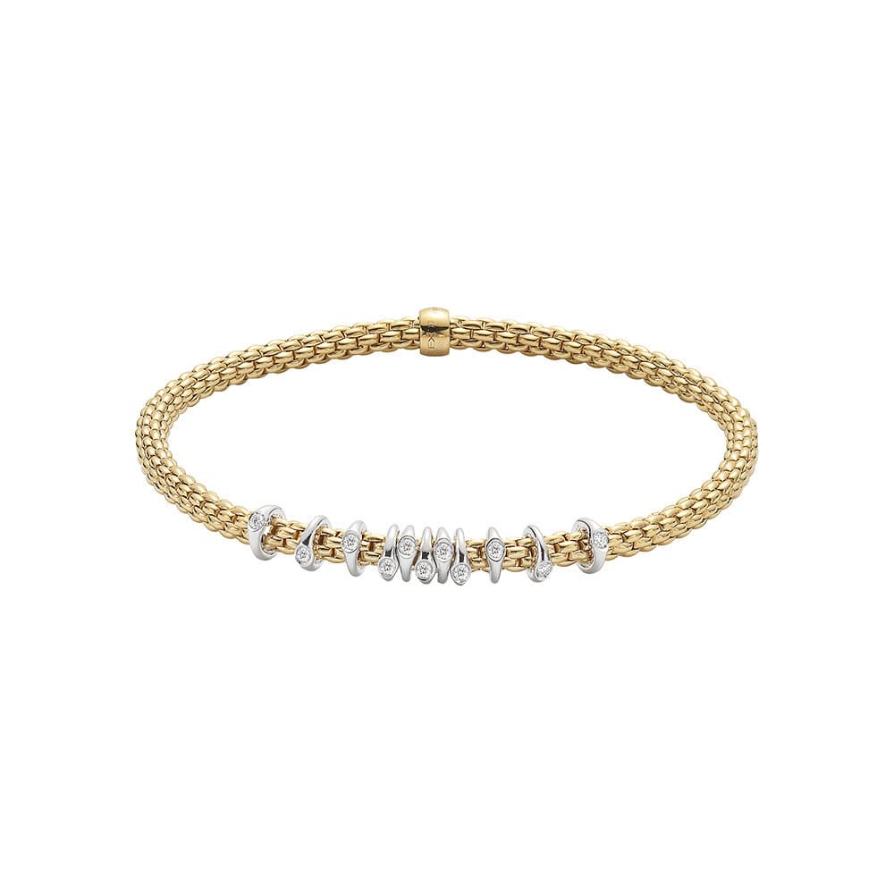 18K YELLOW GOLD STRETCH BRACELET WITH 18K WHITE GOLD WRAPPED STATIONS WITH BEZEL SET ROUND DIAMONDS TOTALING 0.15CTS